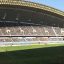 Football match taking place in a crowded stadium