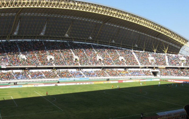 Football match taking place in a crowded stadium